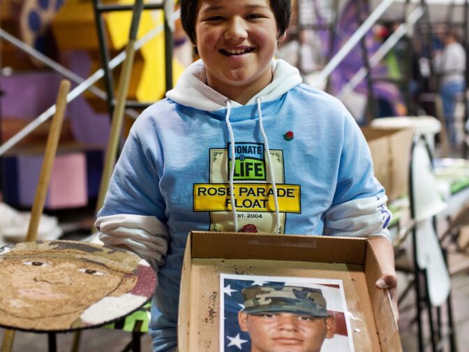 Twelve-year-old Ernesto Bravo Chavez, an organ recipient, holds a photograph of Iraq war veteran Gabriel Barajas. In 2005, 5-year-old Chavez received a kidney from Barajas after he died in a car accident. Chavez holds a florograph, left, that his family made in honor of Barajas.