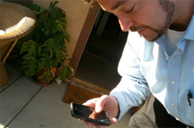 L.A. Unified teacher Daniel Barnhart gets cell phone updates for his trip Thursday to Phoenix to protest SB1070. He's part of a labor union group of several hundred people planning to go for the day.