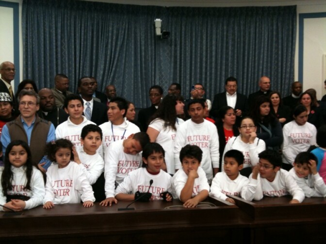 Children at immigration bill introduction wearing tee shirts that read "Future Voter"