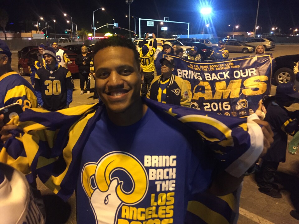 Ryan Washington, who grew up in Inglewood and was 6 years old when the Rams left for St. Louis, celebrates after learning that the team will return to L.A.