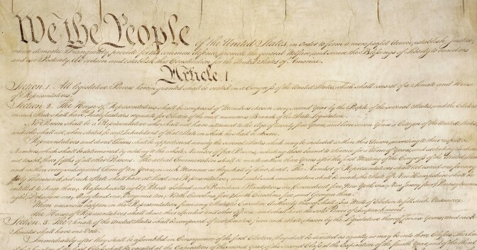 This photo made available by the U.S. National Archives shows a portion of the first page of the United States Constitution. (National Archives via AP)