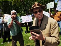 Latin Jazz musicians led by Bobby Matos (front) stage a musical protest outside of a meeting of the National Academy of Recording Arts and Sciences (NARAS) at the Beverly Hilton Hotel in Beverly Hills, California on May 26, 2011. NARAS plans to eliminate 31 categories, among them Latin Jazz, from the Awards beginning in 2012. The pretesters claim the eliminations unfairly target ethnic music and were done without the input of the academy's members.        AFP PHOTO/Mark RALSTON (Photo credit should read MARK RALSTON/AFP/Getty Images)