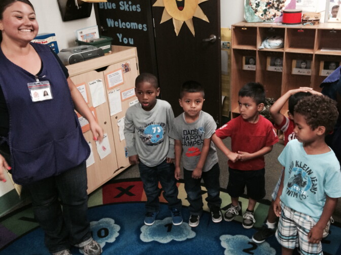 Long Beach preschool teacher, Anabel Lopez, leads children in a round of singing and dancing. Lopez was fearful that she might be laid off due to inconsistent payments by the Department of Education to her organization, Comprehensive Child Development. 