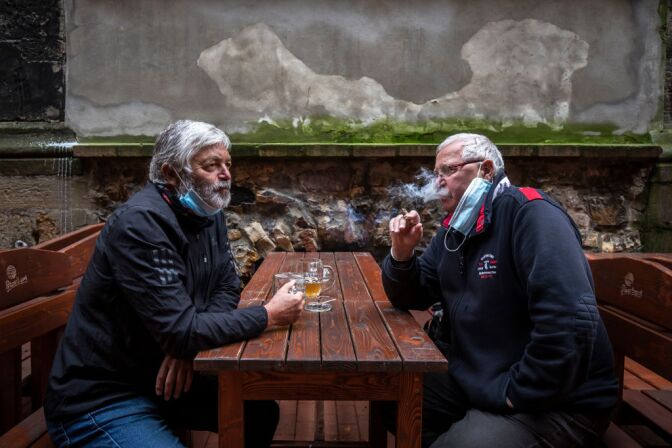 PRAGUE, CZECH REPUBLIC - MAY 11: People drink beer at an outdoor seating section of a pub, as the Czech government lifted more restrictions allowing restaurants with outdoor areas to re-open on May 11, 2020, in Prague, Czech Republic. The Czech government has begun further easing the restrictive measures to slow down the spread of the pandemic COVID-19 disease during the lockdown. (Photo by Gabriel Kuchta/Getty Images)