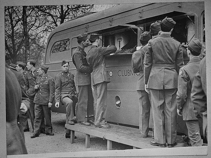 U.S. soldiers receive refreshments, including doughnuts, from an American Red Cross clubmobile in London. Soldiers today still resent a Red Cross move to charge for doughnuts.
