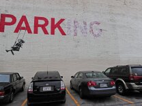 Street graffiti art is seen on a wall in a parking lot in downtown Los Angeles, May 1, 2012. 