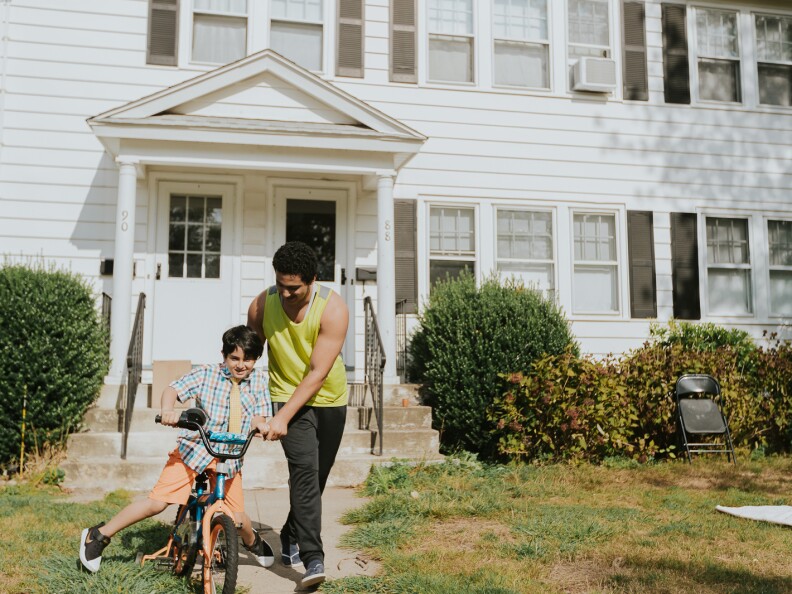 Naji, 19, showing his younger brother Ahmed, 7, how to ride a bike.