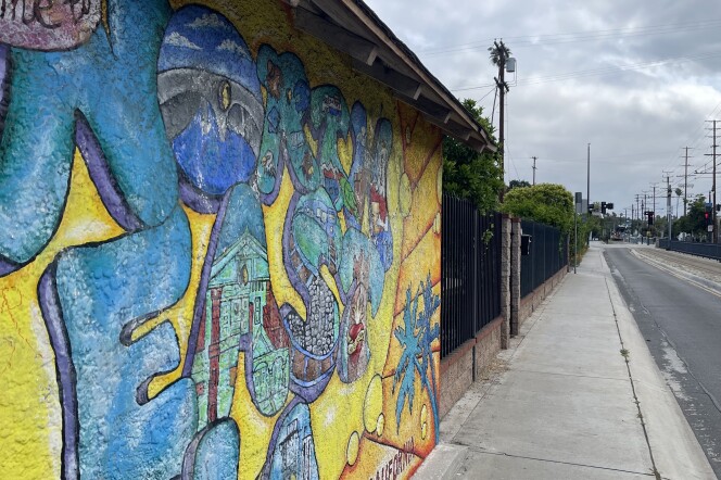 A mural on the side of a building reads "Welcome to Northeast LA" on Marmion Way in Highland Park.