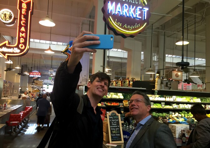 KPCC's John Rabe and reporter Jesse Katz inside LA's Grand Central Market. Jesse's article in the October issue of Los Angeles Magazine covers the market's huge debt, as well as a major discrimination lawsuit.