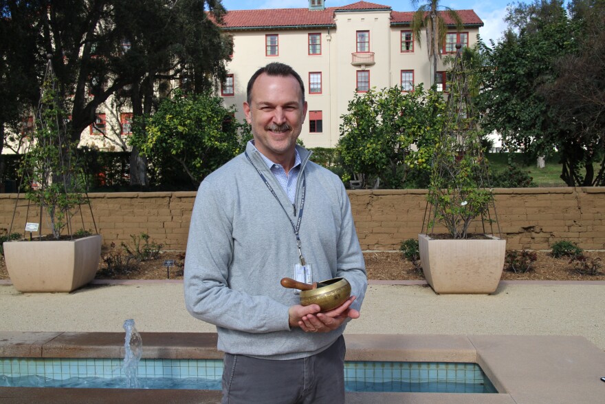 Clinical psychologist Dr. Greg Serpa stands in the garden outside his office at the West Los Angeles VA.