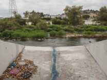Household items sit in a storm drain along the Los Angeles River in Frogtown.