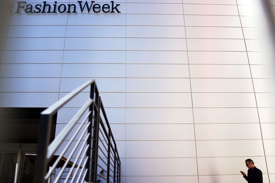 NEW YORK, NY - SEPTEMBER 04: A man stands outside the main tent at New York Fashion Week at Lincoln Center, which officially begins tomorrow, on September 4, 2013 in New York City. One of the most important fashion events on the industry calendar, the week-long event is comprised of dozens of shows, star-attended parties and media events held in various parts of New York City. Fashion Week was started in New York in 1941 by the International Ladies' Garment Workers Union.  (Photo by Spencer Platt/Getty Images)