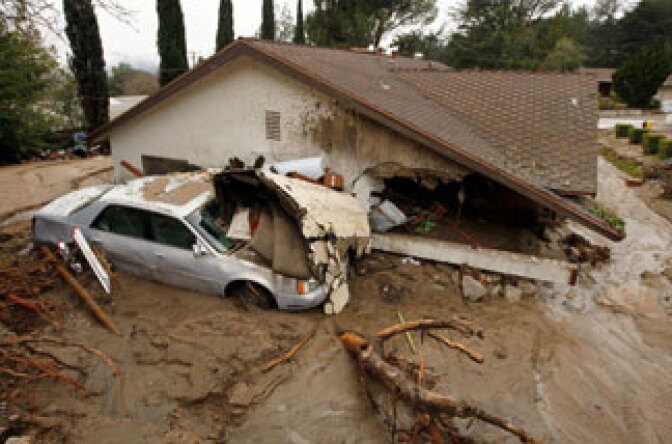 A debris flow damages a home after heavy rains caused mudslides February 6, 2010 in La Canada Flintridge, California. Large wildfires in 2008 and 2009 stripped the hills and mountains of vegetation, resulting in mud and debris flow danger as winter rains pass over foothill communities where thousands of people have been evacuated at times in recent weeks. The threat is particularly high near the San Gabriel Mountains above La Canada-Flintridge area which were denuded of natural flood-controlling vegetation by the 250-plus square mile Station. At least 40 homes have been severely damaged and 500 were evacuated.
