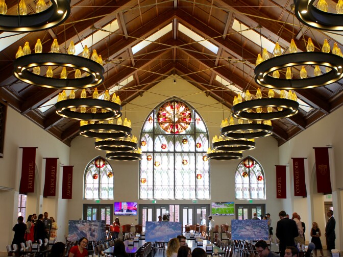 A giant new dining hall, with its high arched ceiling and stained glass, might remind students of where Harry Potter and his friends ate at Hogwarts. 