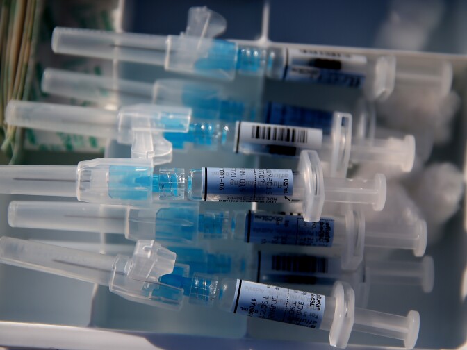 Syringes filled with flu vaccine sit on a table during a drive-thru flu shot clinic at Doctors Medical Center on November 6, 2014 in San Pablo, California. Doctors Medical Center hosted a drive-thru flu shot clinic offering free vaccines for any community member over the age of 18.
