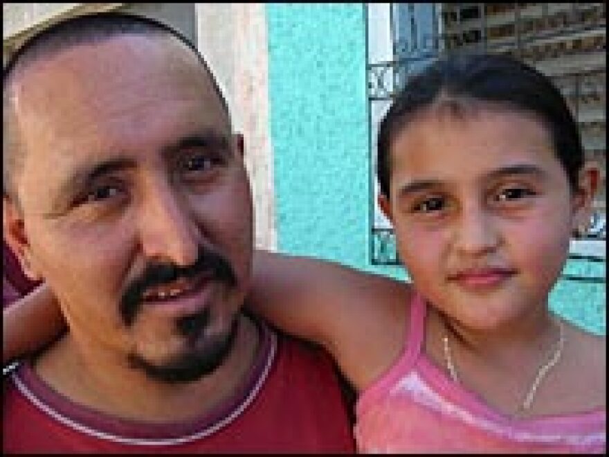 Ernesto Miranda, aka "Smokey," pictured in 2004 with his daughter Maybelline in front of his home outside San Salvador.