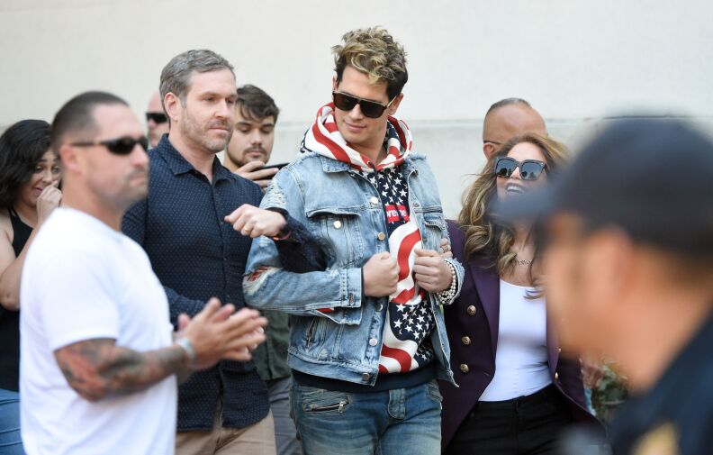 Conservative commentator Milo Yiannopoulos is escorted onto the University of California, Berkeley campus where he is expected to speak to dozens of supporters on September 24, 2017.
Although a student group cancelled plans for Free Speech Week, Yiannopoulos was able to speak on campus surrounded by a heavy police presence.   / AFP PHOTO / Josh Edelson        (Photo credit should read JOSH EDELSON/AFP/Getty Images)