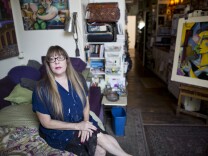 Painter Jett Jackson sits in her 275-square-foot live and work space in the Arts District on Thursday, August 20, 2015. "It's like living on a submarine or a boat," Jackson said of her apartment. "I've spent years compacting."