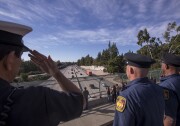 Los Angeles Fire Department Task Force 12 firefighters salute as a procession carries the body of Cory Iverson, 32, a fire engineer for Cal Fire San Diego who died fighting the Thomas Fire, on December 17, 2017.