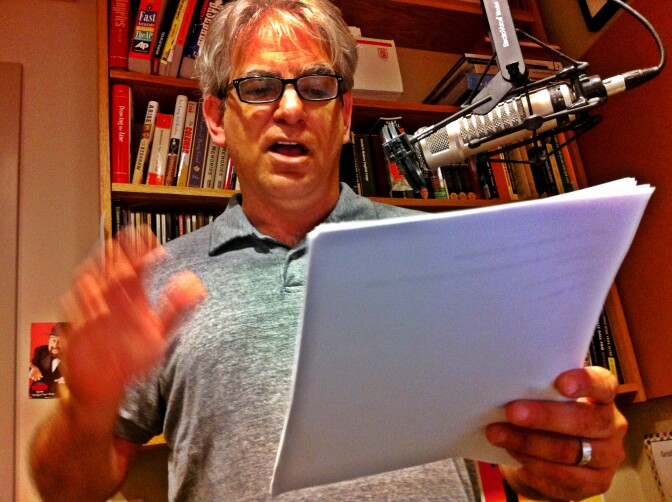 Commentator Dylan Brody reading a radio script in the Off-Ramp studio.