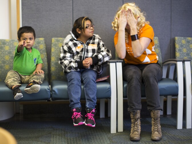 Actress Scarlett Redmond interacts with Jake Gonzalez, 2, left, and Julissa Tagle, 10, while performing a skit in the Urology Waiting Room at Children's Hospital Los Angeles on Monday, Feb. 23. 