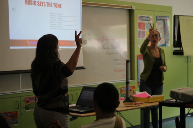 Teaching artists Deirdre Marlowe and Mina Bloom talk to students about the importance of using music that matches the tone of the lyrics. 
