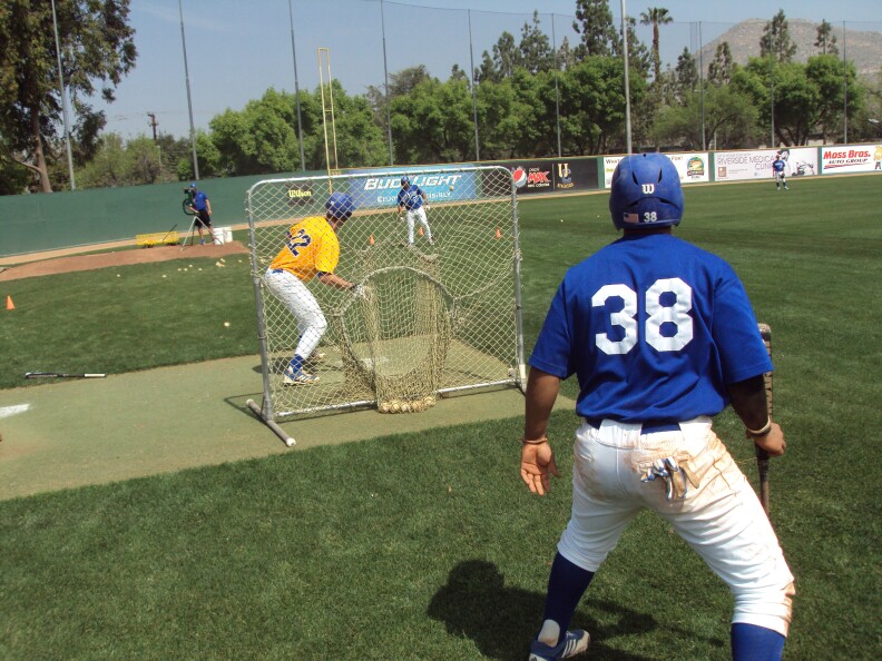 Players practicing their bunt at the UC Highlander's field.