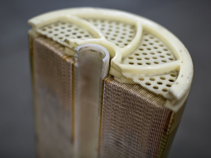 A cross-section of a reverse osmosis pressure vessel shows 7 membrane sheets inside. The facility currently has 2,250 of these vessels which come from Australia.