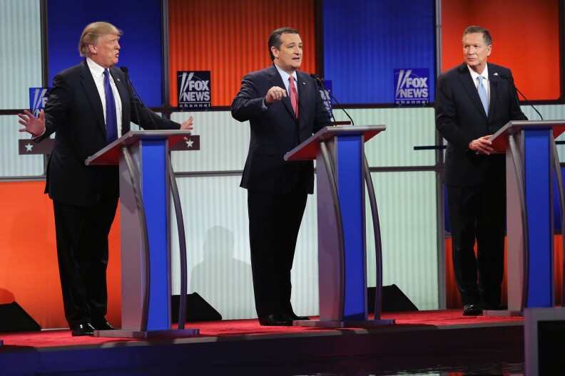File: Republican presidential candidates (L to R) Donald Trump, Sen. Ted Cruz (R-TX), and Ohio Gov. John Kasich participate in a debate sponsored by Fox News at the Fox Theatre on March 3, 2016 in Detroit, Michigan.