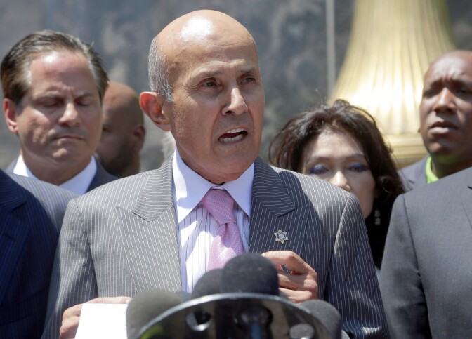 Former Los Angeles County Sheriff Lee Baca speaks to the media after leaving federal court in Los Angeles on Aug. 1, 2016. Baca withdrew a guilty plea and chose to go to trial on a charge of lying to federal authorities in an effort to thwart an FBI investigation into abuses at the jails he ran.