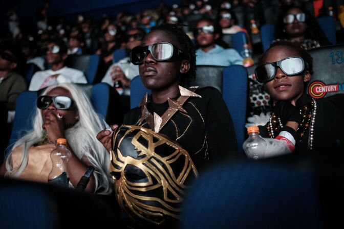 Csosplayers watch the film "Black Panther" in 3D which featuring Oscar-winning Mexico born Kenyan actress Lupita Nyongo during Movie Jabbers Black Panther Cosplay Screening in Nairobi, Kenya, on February 14, 2018.
Black Panther is a Superhero film based on the Marvel Comics character featured the first black superhero as Black Panther in advanced fictional African nation. Nyongo who won the Academy Award for best supporting actress in 12 Years a Slave in 2014, plays a major role as a female warrior in the film.  / AFP PHOTO / Yasuyoshi CHIBA        (Photo credit should read YASUYOSHI CHIBA/AFP/Getty Images)