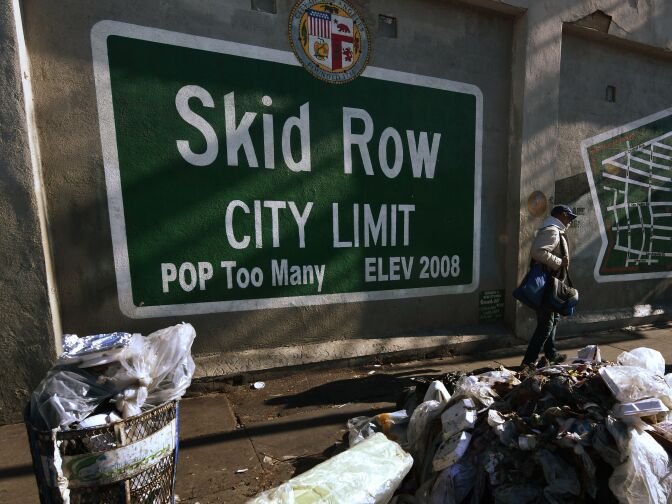 Trash lies beside the Skid Row City Limit mural as the city begins its annual homeless count in Los Angeles, California on January 26, 2018