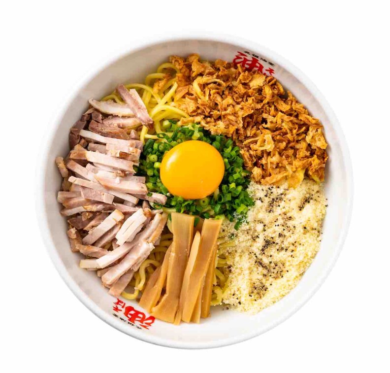 A bowl of aburado ramen with ingredients side by side topped by a raw egg.