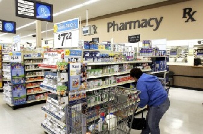 A woman shops in the pharmacy area of a Wal-Mart store.