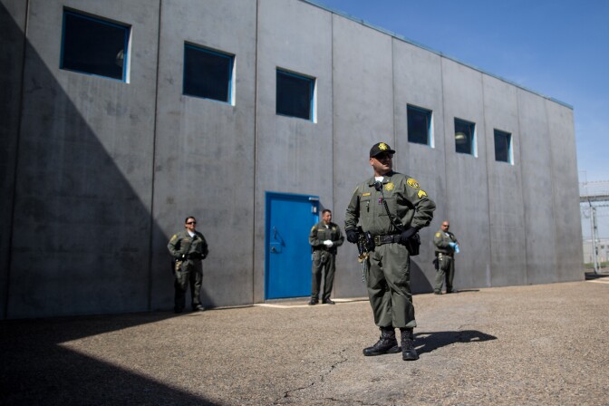 Guards prepare to search inmates in the prison's general population before they come out on the prison yard. General population inmates spend many hours a day outside or in common indoor spaces.