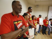 Cecil Canton, left, a criminal justice professor at California State University, Sacramento, joins other faculty members at a news conference, at CSU, Sacramento, to discuss the independent report that supports the position that faculty members at the California State University system are underpaid, Monday, March 28, 2016. The administration says it doesn't have the money to give a 5 percent raise called for by the faculty association and has offered a 2 precent raise. 