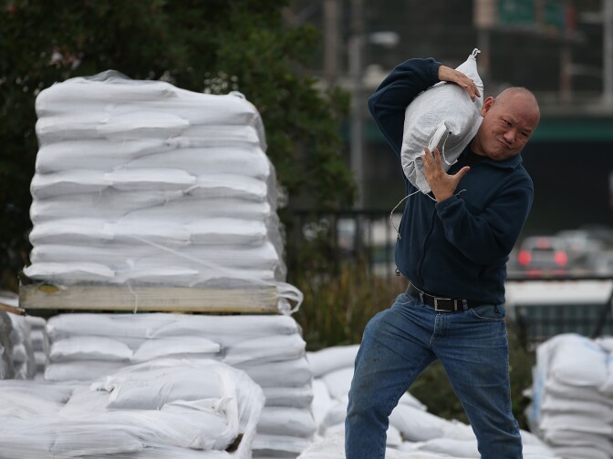 SAN FRANCISCO, CA - DECEMBER 10:  A man lifts sandbags that are being given away for free at the San Francisco Department of Public Works corporation yard on December 10, 2014 in San Francisco, California. The San Francisco Bay Area is bracing for a severe storm that is expected to bring high winds and heavy rain that could topple trees and cause widespread flooding. Urban areas could see up to 6 inches of rain in less than 24 hours.  (Photo by Justin Sullivan/Getty Images)