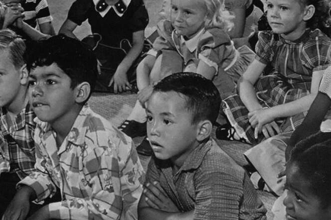 Archival photo of young students of mixed ethnicities.