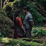 Two people standing in the forest