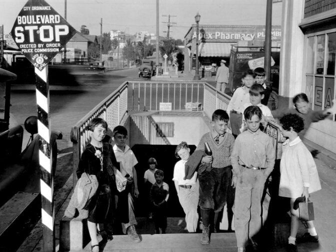 From Dec. 6, 1927: "School tunnel at Sunset Boulevard and Logan Street, south entrance. Apex Pharmacy is in the background along with a Challenge Cream and Butter Association Truck."