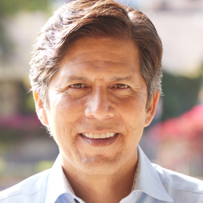 Headshot of a smiling man in a collared shirt. His hair is light brown with a dusting of gray over his ears.