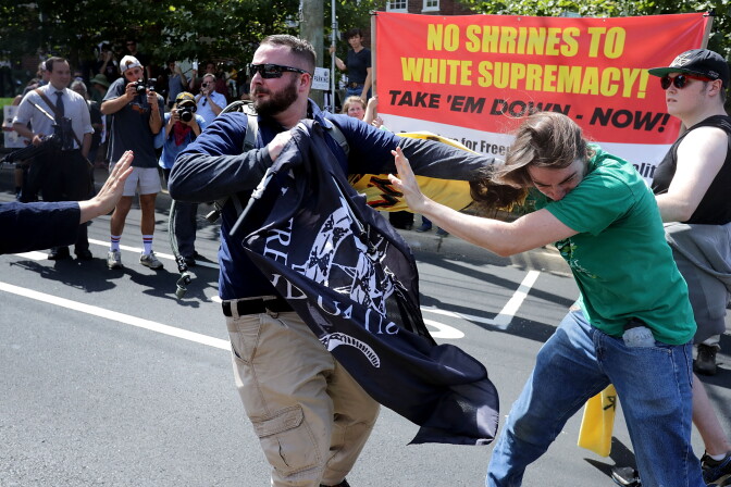 CHARLOTTESVILLE, VA - AUGUST 12:  White nationalists, neo-Nazis and members of the "alt-right" clash with counter-protesters in the street after the "Unite the Right" rally was delcared a unlawful gathering by Virginia State Police August 12, 2017 in Charlottesville, Virginia. After clashes with anti-fascist protesters and police the rally was declared an unlawful gathering and people were forced out of Lee Park, where a statue of Confederate General Robert E. Lee is slated to be removed.  (Photo by Chip Somodevilla/Getty Images)