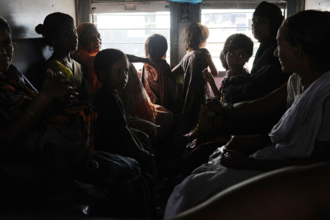 Indian women and children wait inside a darkened train carriage at a railway station in New Delhi on July 31, 2012. A massive power failure hit India for the second day running as three regional power grids collapsed, blacking out more than half the country in a crisis affecting over 600 million people.