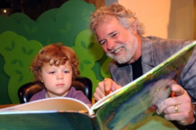 Grandson Miles reads with his grandfather, Chuck Leavell.