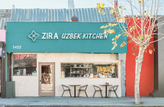 The colorful exterior of a restaurant, which is painted in teal and an orange-red. On the front it ways Zira, Uzbek Kitchen.