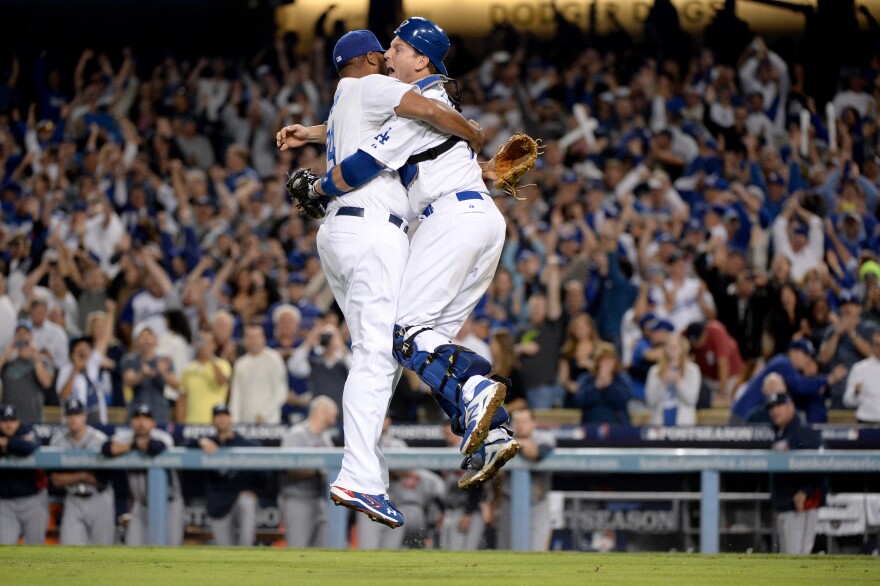 LOS ANGELES, CA - OCTOBER 07:  Catcher A.J. Ellis #17 and Kenley Jansen #74 of the Los Angeles Dodgers celebrate after the Dodgers defeat the Atlanta Braves 4-3 in Game Four of the National League Division Series at Dodger Stadium on October 7, 2013 in Los Angeles, California.  (Photo by Harry How/Getty Images)