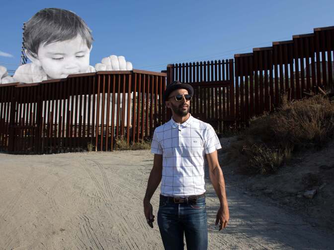 French artist JR is pictured near his artwork on the US-Mexico border in Tecate, California, United States on September 6, 2017.