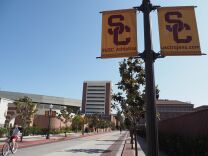 A young man rides a bicycle on the campus of the University of Southern California (USC) in Los Angeles, California on May 17, 2018. - USC was in turmoil as it was accused of being too slow to act on accusations of abusive sexual practises by Dr. George Tyndall. A gynaecologist who saw student patients at the Engemann Student Health Center.  USC has already received more than 85 current and former student testimonies accusing Tyndall of abuse during examinations. (Photo by Robyn Beck / AFP)        (Photo credit should read ROBYN BECK/AFP/Getty Images)