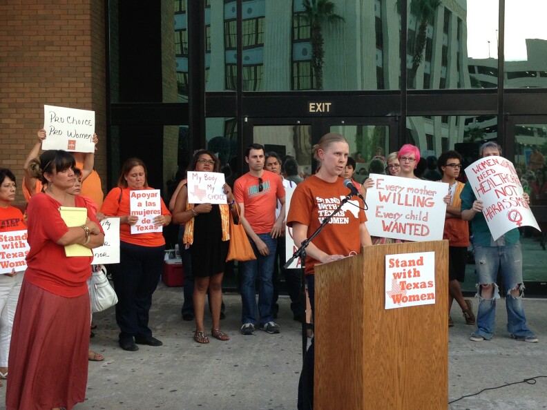Opponents of the stricter regulations on abortion rally outside the county courthouse in El Paso.