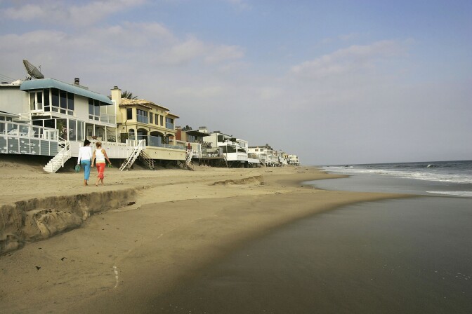 MALIBU, CA - APRIL 18:  Luxurious beach houses crowd the shoreline hiding Carbon Beach, a public beach that was gotten to through a recently opened public accessway next to music producer David Geffen's beach house, on April 18, 2005 in Malibu, California. The gate was found re-locked later that afternoon. By opening the gate, Geffen would be fulfilling a 22-year-old legal promise to open a public pathway across his property in exchange for permits from the Coastal Commission to begin building his Cape Cod-style compound across multiple lots on Carbon Beach. In giving up the gate key, the music mogul also stops daily fines of $1,000 a day from accumulating.  (Photo by David McNew/Getty Images)